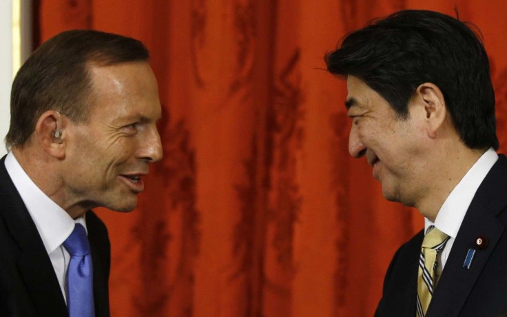 Australia's Prime Minister Tony Abbott talks to Japan's Prime Minister Shinzo Abe