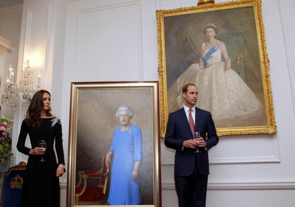 Britains Catherine, Duchess of Cambridge, and her husband Prince William stand next to paintings of Queen Elizabeth as they attend a state reception at Government House in Wellington