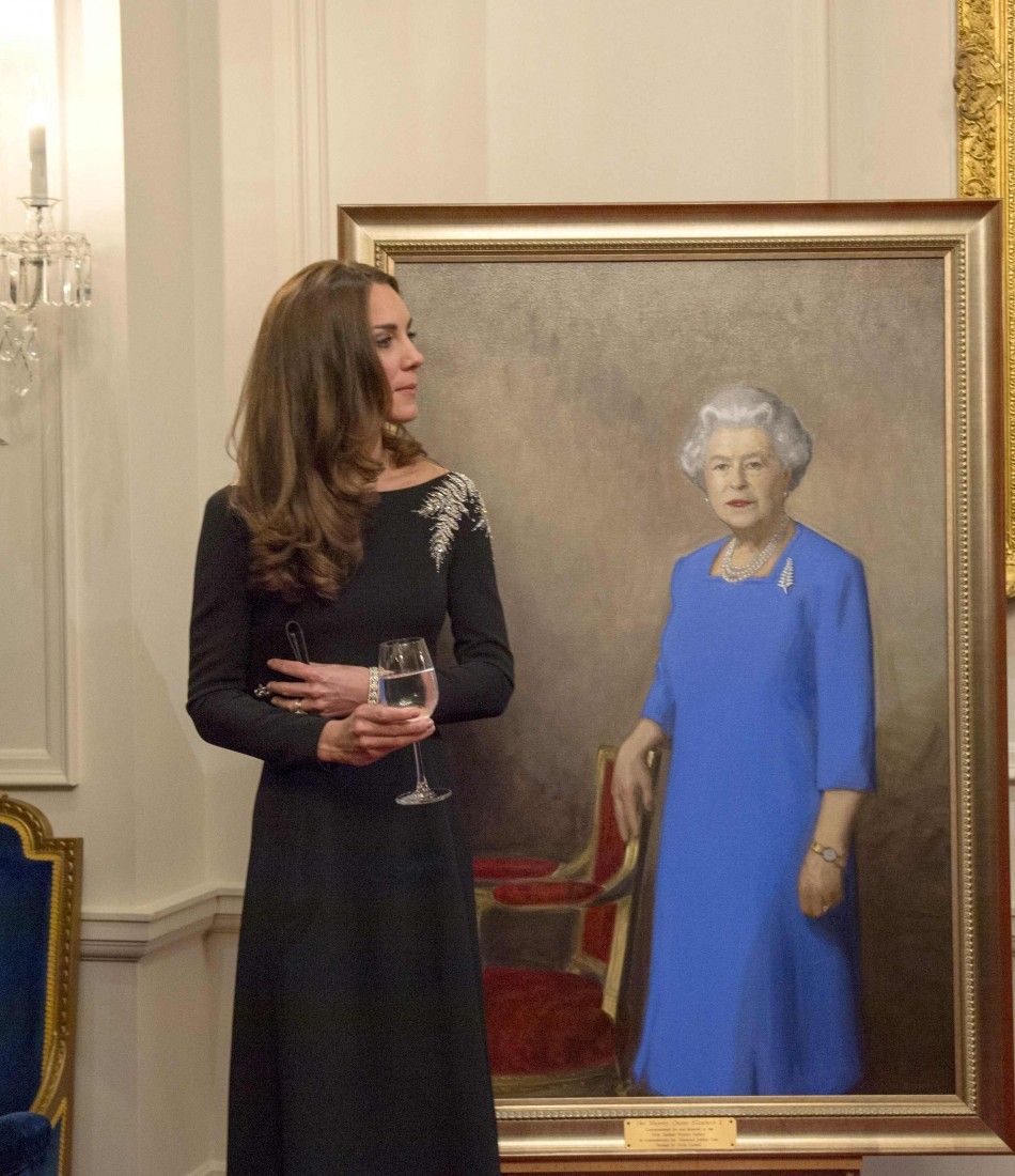 Britains Catherine, Duchess of Cambridge stands next to a portrait of Britains Queen Elizabeth after she and her husband Prince William had unveiled it, as they attend a state reception at Government House in Wellington