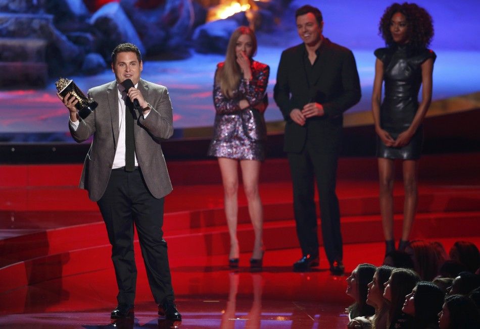 Jonah Hill accepts the award for best comedic performance for quotThe Wolf of Wall Streetquot on stage as Seth MacFarlane and Amanda Seyfried watch R at the 2014 MTV Movie Awards in Los Angeles, California  April 13, 2014.  REUTERSLucy Nicholson  