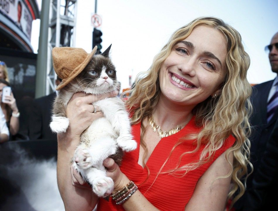Grumpy Cat arrives with his owner Tabatha Bundesen at the 2014 MTV Movie Awards in Los Angeles, California  April 13, 2014.  REUTERSLucy Nicholson 