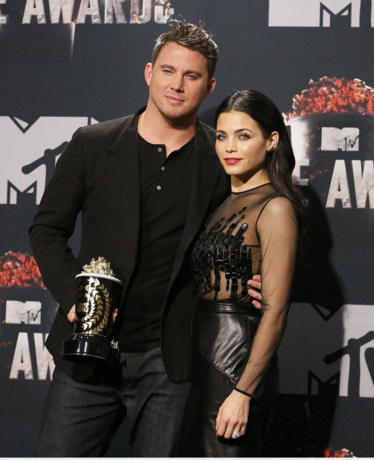 Channing Tatum with his wife Jenna Dewan pose with his Trailblazer award backstage at the 2014 MTV Movie Awards in Los Angeles