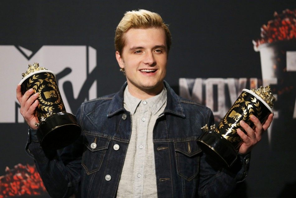Josh Hutcherson poses backstage with his awards for Best Male Performance and Best Movie of the Year for his performance in quotThe Hunger Games Catching Firequot at the 2014 MTV Movie Awards in Los Angeles