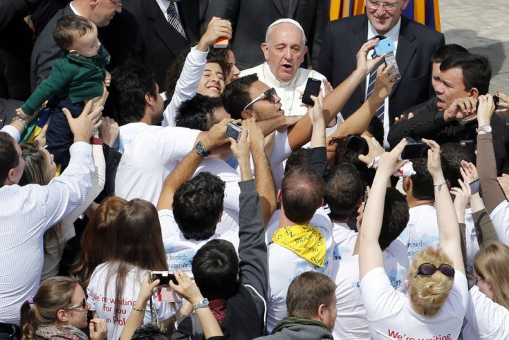 Pope Francis greets youths after leading the Palm Sunday mass at Saint Peter&#039;s Square at the Vatican
