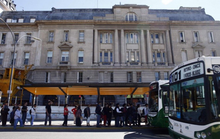 People line up at a bus stop in Buenos Aires April 9, 2014. Opposition labor unions hold a 24-hour strike to press for wage increases in line with inflation rate, estimated by private economists at more than 30 percent per year. The strike will include pu