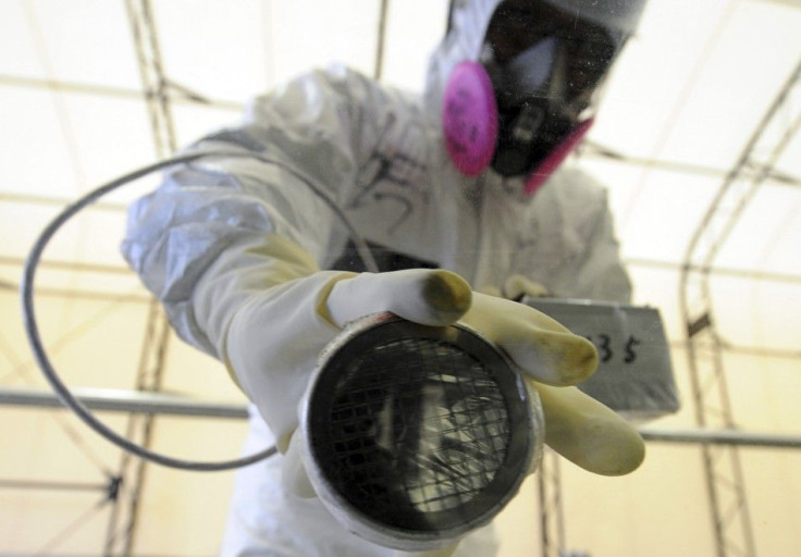 A worker takes radiation readings on the window of a bus at the screening point of the Tokyo Electric Power Company&#039;s (TEPCO) tsunami-crippled Fukushima Daiichi nuclear power plant in Fukushima prefecture in this June 12, 2013 file photo. Since March