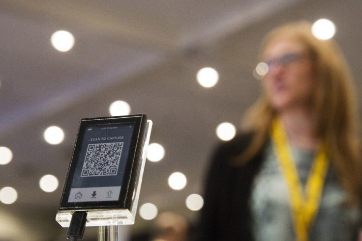 A woman stands behind a digital Bitcoin wallet during the Inside Bitcoins: The Future of Virtual Currency Conference in New York April 8, 2014. REUTERS/Lucas Jackson