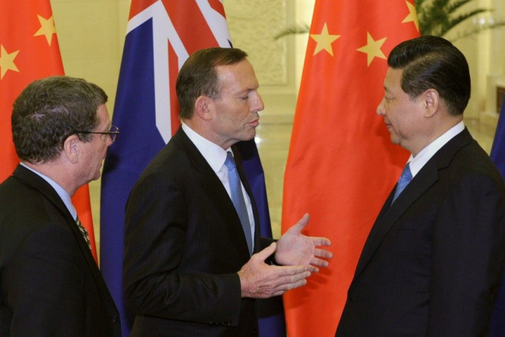 Australian Prime Minister Tony Abbott (C) talks to Chinese President Xi Jinping (R) before a meeting at the Great Hall of the People in Beijing, April 11, 2014. REUTERS/Parker Song/Pool