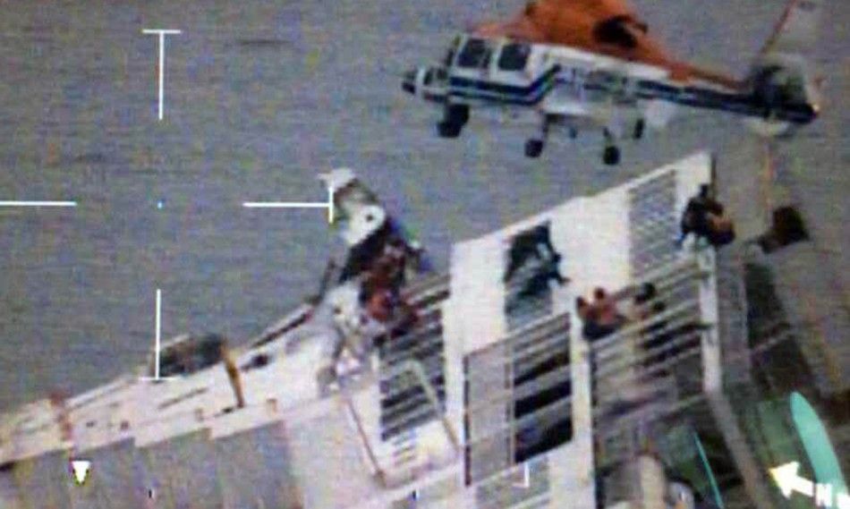 A South Korean maritime police helicopter rescues passengers from a sinking ship in the sea off Jindo, April 16, 2014, in this still image provided by Korea Coast Guard and released by Yonhap. All 338 high school students and teachers on board a South Kor