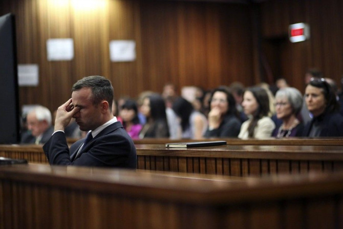Olympic and Paralympic track star Oscar Pistorius reacts during his trial at North Gauteng High Court in Pretoria April 15, 2014. The prosecutor in the murder trial of Pistorius ended his five-day cross-examination of the double amputee track star on Tues