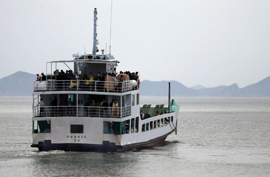 A ferry ship carrying family members of missing passengers who were on the South Korean ferry quotSewolquot which sank in the sea off Jindo, sails towards the accident site off a port where family members of missing passengers have gathered, in Jindo 