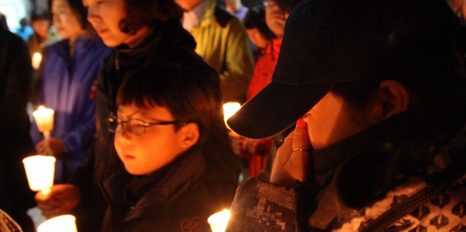 A family member of a missing student who was on the South Korean ferry quotSewolquot which sank in the sea off Jindo attends a candlelight vigil at Danwon High School in Ansan April 16, 2014. More than 280 people, many of them students from the same h