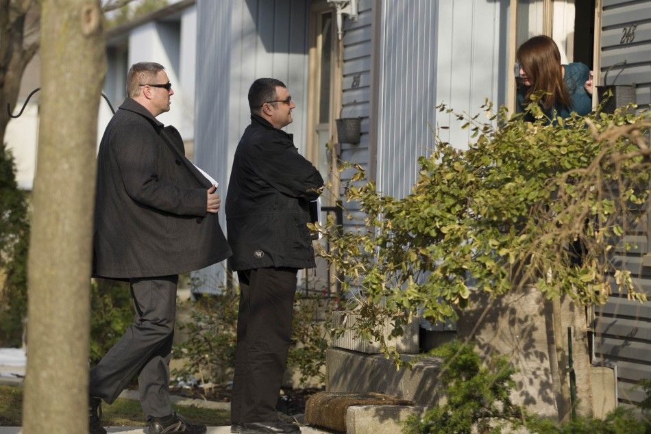 Royal Canadian Mounted Police RCMP investigators canvas the London, Ontario neighbourhood April 16, 2014, around the home of Stephen Solis-Reyes who has been charged in connection with exploiting the quotHeartbleedquot bug to steal taxpayer data fro