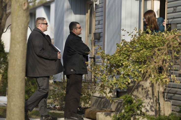 Royal Canadian Mounted Police (RCMP) investigators canvas the London, Ontario neighbourhood April 16, 2014, around the home of Stephen Solis-Reyes who has been charged in connection with exploiting the &quot;Heartbleed&quot; bug to steal taxpayer data fro
