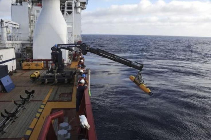 Operators aboard the Australian Defense Vessel Ocean Shield move the U.S. Navy's Bluefin 21 autonomous underwater vehicle