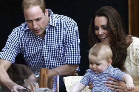 Britain's Catherine, Duchess of Cambridge, holds her son George, next to her husband Prince William as they meet a bilby named George after the young prince, at Taronga Zoo in Sydney