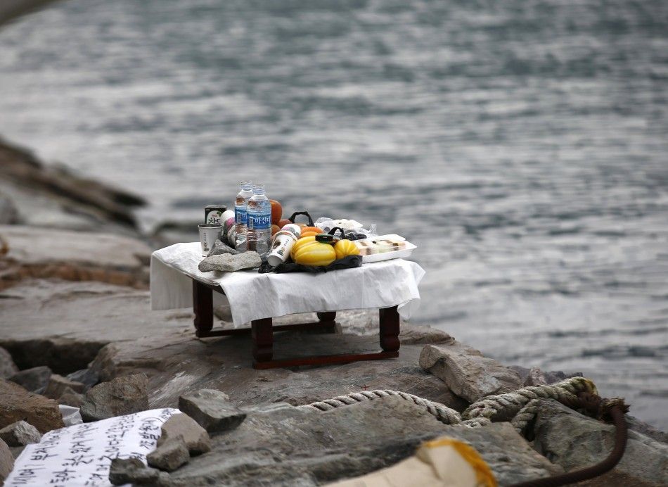 An altar with prayer offerings for missing passengers onboard South Korean ferry Sewol, which capsized on Wednesday, is seen next to the sea at a port where family members of missing passengers are waiting for news from rescue and salvage teams in Jindo A