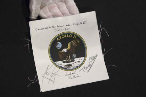 An Apollo 11 emblem, flown into lunar orbit and signed by the crew - Neil Armstrong, Michael Collins, and Buzz Aldrin, which is estimated at $40,000 to $60,000