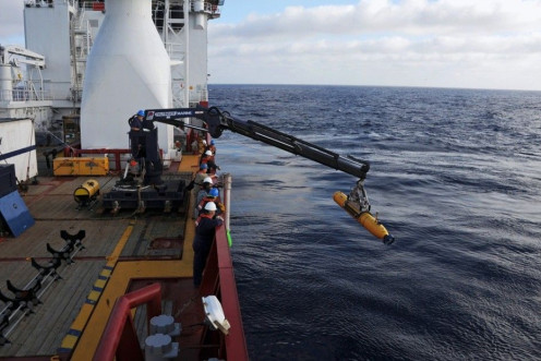 Handout of crew aboard the Australian Defence Vessel Ocean Shield moving the U.S. Navy's Bluefin-21 into position for deployment, in the southern Indian Ocean to look for the missing Malaysia Airlines flight MH370