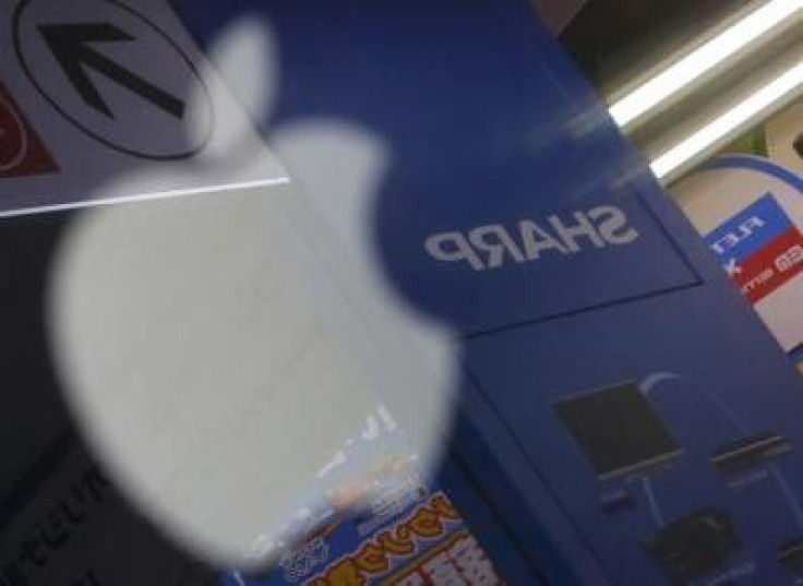 The logo of Sharp Corp is seen reflected on Apple Inc's MacBook Pro at an electronics store in Tokyo