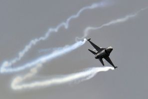 A General Dynamics F-16 Fighting Falcon fighter jet performs during an air display at the Farnborough Airshow in Farnborough