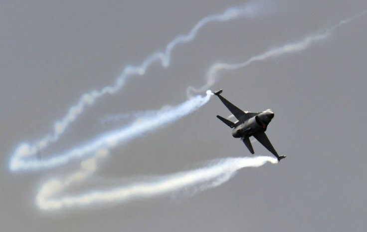 A General Dynamics F-16 Fighting Falcon fighter jet performs during an air display at the Farnborough Airshow in Farnborough