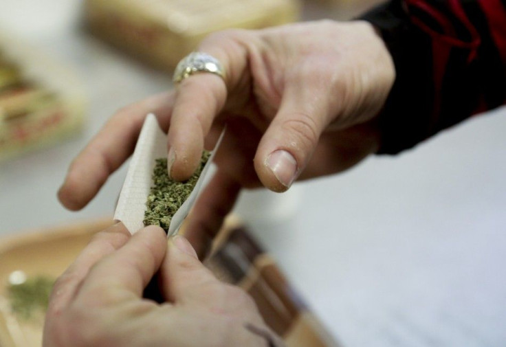 A participant practices rolling a joint at the Cannabis Carnivalus 4/20 event in Seattle