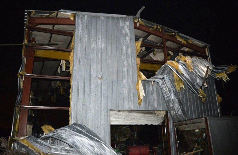 Debris is seen at a damaged business after a tornado hit the town of Mayflower, Arkansas around 730 pm CST, late April 27, 2014. Tornadoes ripped through the south-central United States on Sunday, killing at least 12 people in Arkansas and Oklahoma and w