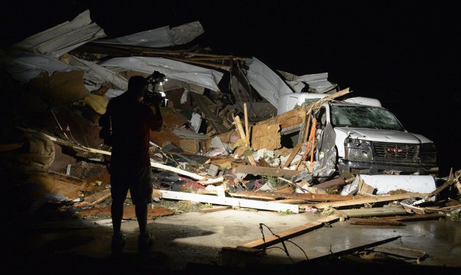 First In Video news video photographer Brad Mack covers the damage seen after a tornado hit the town of Mayflower, Arkansas around 730 pm CST, late April 27, 2014. Tornadoes ripped through the south-central United States on Sunday, killing at least 12 pe