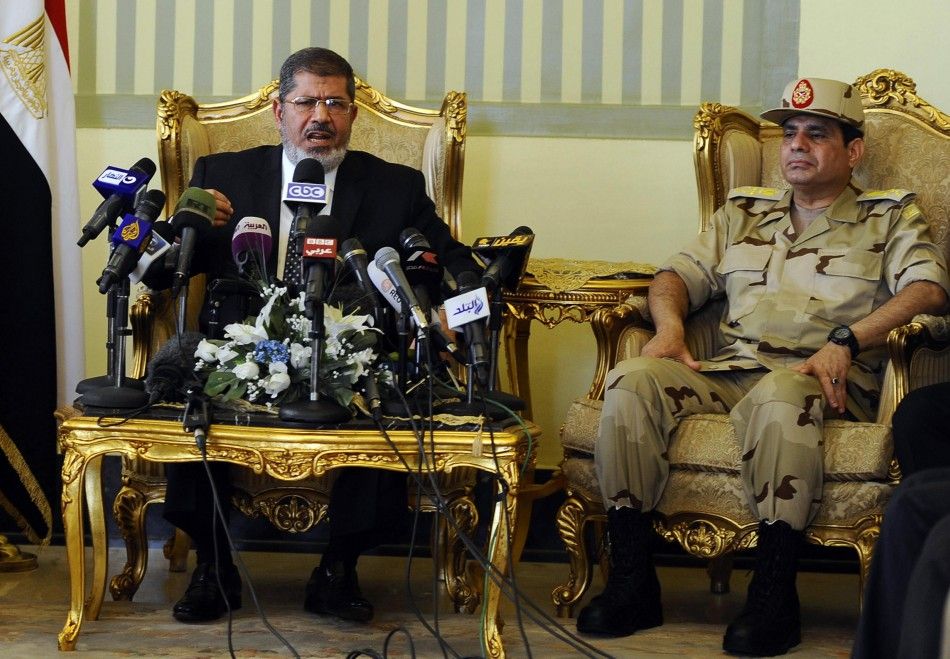 Egypts President Mohamed Mursi L and Defence Minister Abdel Fattah al-Sisi R attend a news conference on the release of the soldiers who were kidnapped last week, in Cairo in this May 22, 2013 file photo. REUTERSStringer