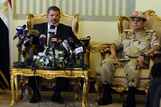 Egypt's President Mohamed Mursi (L) and Defence Minister Abdel Fattah al-Sisi (R) attend a news conference on the release of the soldiers who were kidnapped last week, in Cairo in this May 22, 2013 file photo. REUTERS/Stringer