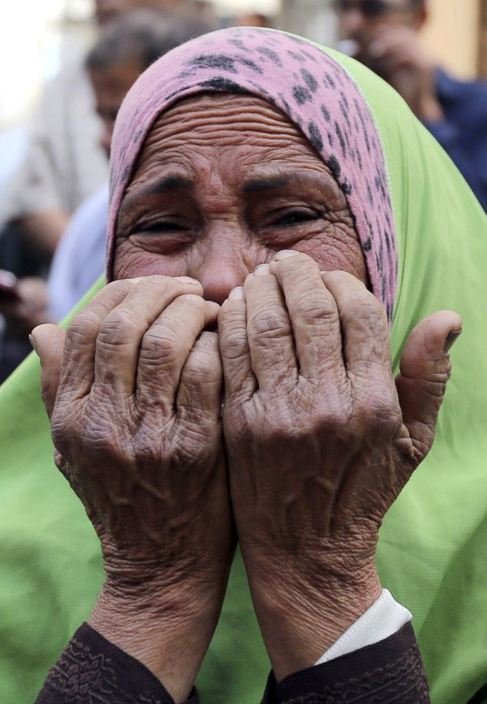 The mother of an accused supporter of ousted President Mohamed Mursi reacts in front of the court in Minya, south of Cairo, after hearing the sentence handed to Muslim Brotherhood leader Mohamed Badie and other Brotherhood supporters April 28, 2014. An Eg