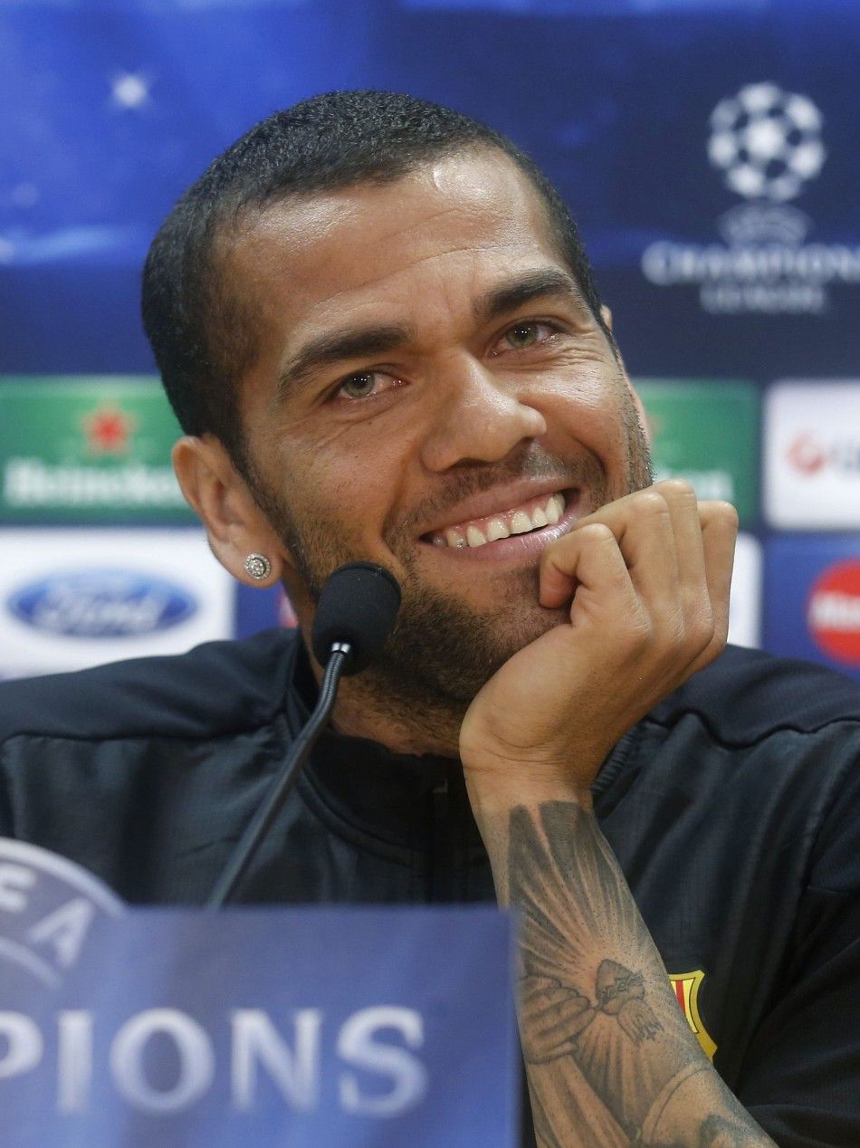 Barcelonas player Dani Alves smiles during a news conference at Joan Gamper training camp, near Barcelona, March 31, 2014. Barcelona and Atletico Madrid will play their Champions League quarter-final, first leg soccer match on Tuesday. REUTERSAlbert Gea