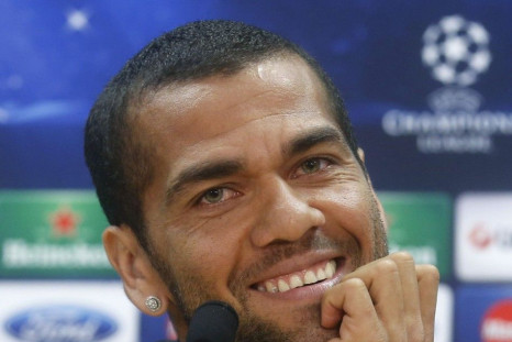 Barcelona's player Dani Alves smiles during a news conference at Joan Gamper training camp, near Barcelona, March 31, 2014. Barcelona and Atletico Madrid will play their Champions League quarter-final, first leg soccer match on Tuesday. REUTERS/Albert Gea