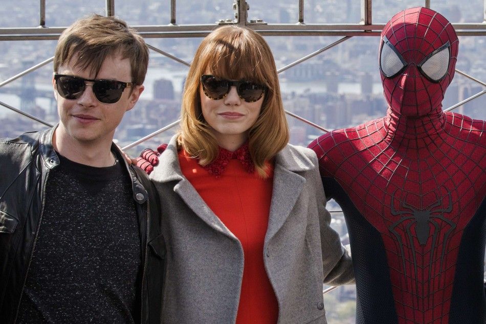 Cast members Dane DeHaan and Emma Stone pose with a stunt man dressed as Spider-Man during a photo call for the film quotThe Amazing Spider-Man 2quot, at the Empire State Building in New York