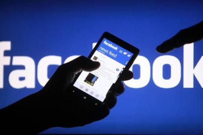 A smartphone user shows the Facebook application on his phone