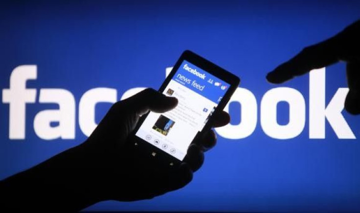 A smartphone user shows the Facebook application on his phone