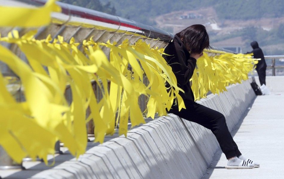 A family member of missing passengers onboard the sunken passenger ship Sewol cries as she waits for news from a search and rescue operation team at a port in Jindo May 1, 2014. The Sewol ferry sank on a routine trip south from the port of Incheon to the 