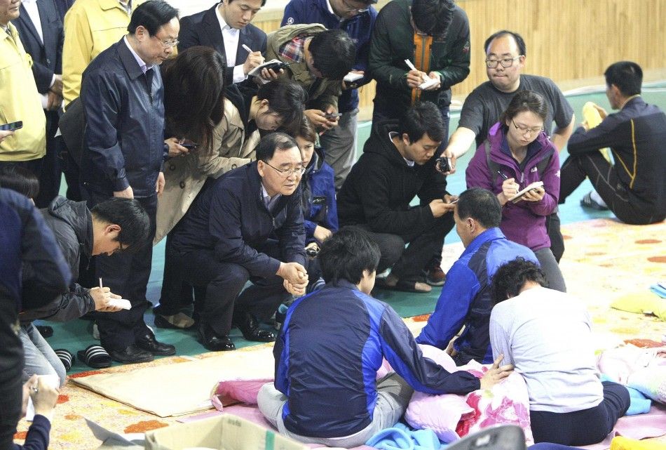 South Korean Prime Minister Chung Hong-won C talks with family members of missing passengers onboard the sunken passenger ship Sewol at a makeshift accommodation at a gym in Jindo May 1, 2014. Chung announced his resignation last Sunday over the governm