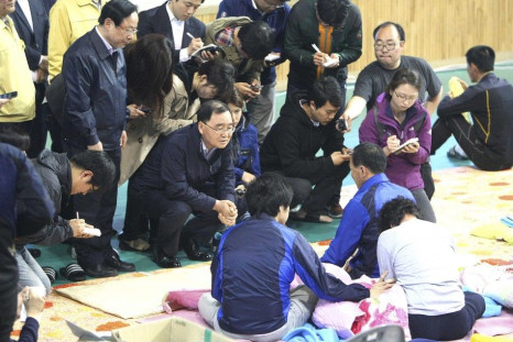 South Korean Prime Minister Chung Hong-won (C) talks with family members of missing passengers onboard the sunken passenger ship Sewol at a makeshift accommodation at a gym in Jindo May 1, 2014. Chung announced his resignation last Sunday over the governm