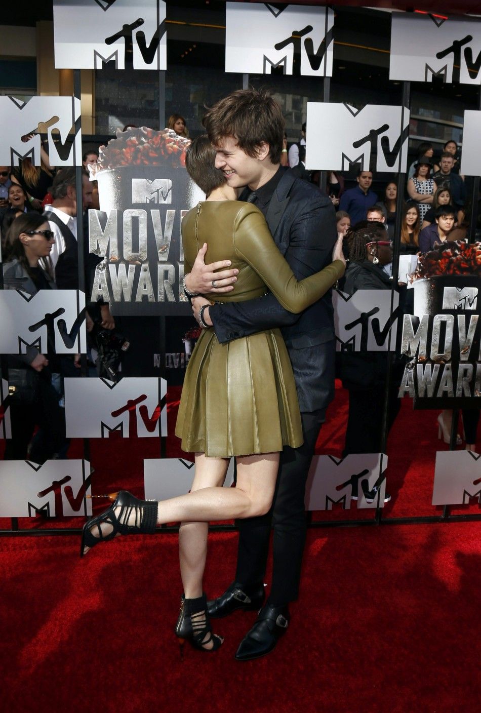 Shailene Woodley greets actor Ansel Elgort on the red carpet at the 2014 MTV Movie Awards in Los Angeles