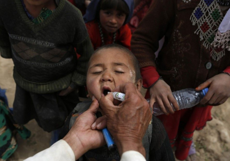 An Afghan child receives polio vaccination drops near the site of a landslide at the Argo district in Badakhshan province May 4, 2014. REUTERS/Mohammad Ismail