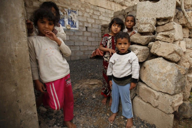 Children stand outside a house during a polio immunization campaign in an outskirt of the Yemeni capital Sanaa April 7, 2014. Yemen's Ministry of Public Health and Population launched a national polio immunization campaign on Monday, according to World He