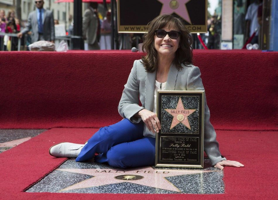 Actress Sally Field poses on her star after it was unveiled on the Walk of Fame in Hollywood