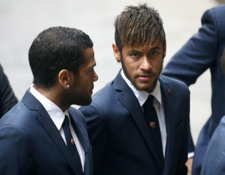 FC Barcelona's soccer players Neymar (R) and Dani Alves arrive to attend former coach Tito Vilanova's memorial service at Barcelona Cathedral April 28, 2014. Vilanova has died following a battle with cancer that forced him to stand down at the e
