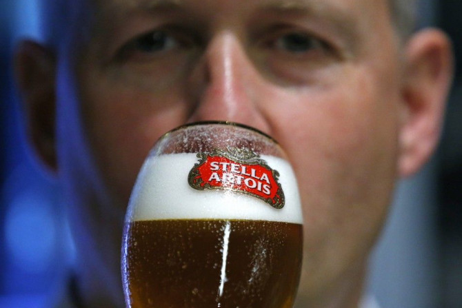A waiter tastes a beer ahead of an Anheuser-Busch InBev shareholders meeting in Brussels April 30, 2014.