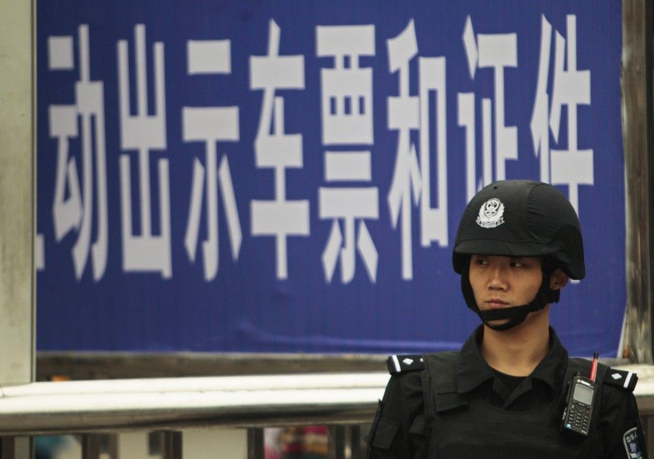 A policeman stands guard at a railway station after a knife attack in Guangzhou, Guangdong province May 6, 2014. REUTERSAlex Lee