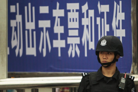 A policeman stands guard at a railway station after a knife attack in Guangzhou, Guangdong province May 6, 2014. REUTERS/Alex Lee