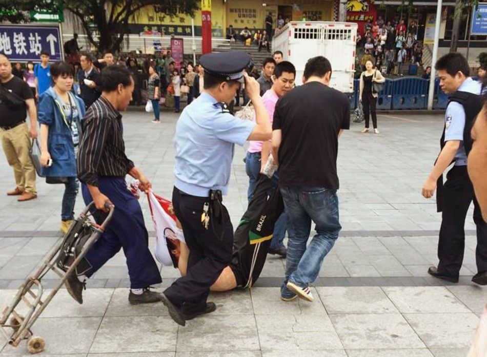 A man, whom local media say is a suspect, is detained after a knife attack at a railway station in Guangzhou, Guangdong province May 6, 2014. REUTERSStringer
