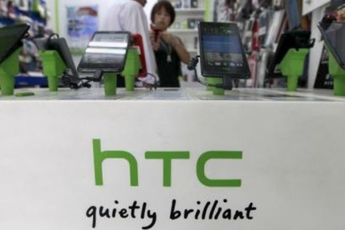 Customers look at HTC smartphones in a mobile phone shop in Taipei 
